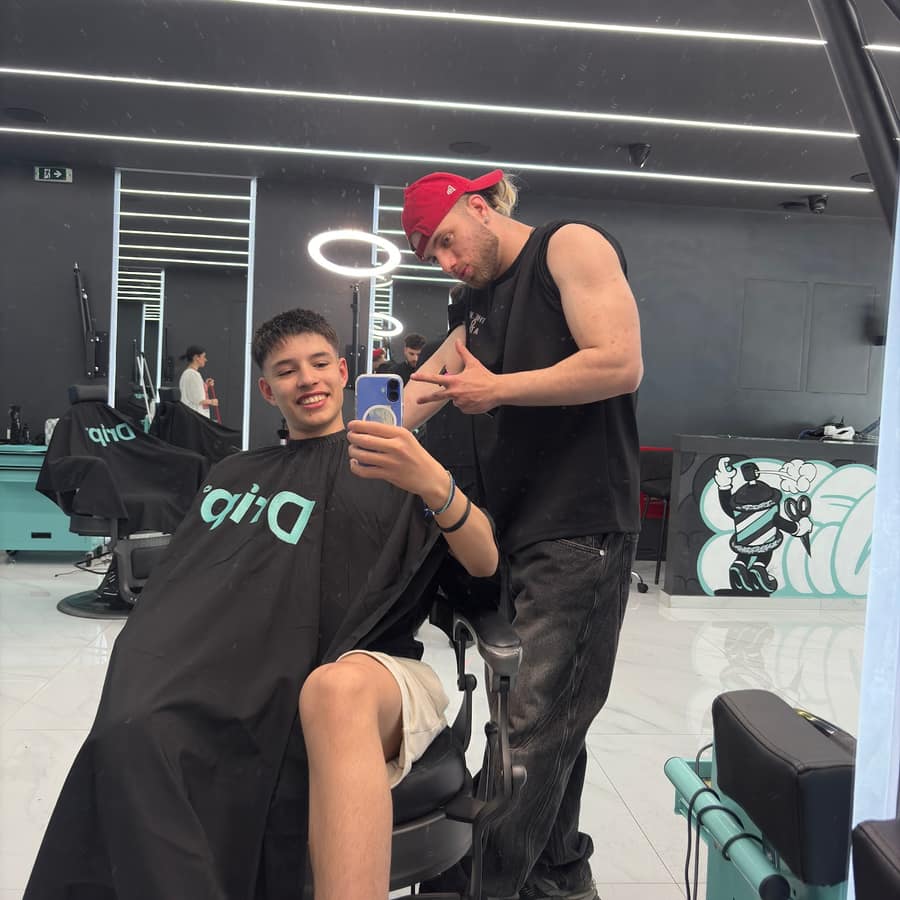 Ο barber με τον πελάτη κάτω από τον φωτεινό κύκλο
